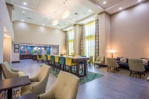 a lobby with tables and chairs and a cafeteria at Hampton Inn & Suites Yonkers - Westchester in Yonkers