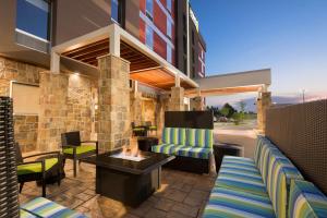 patio z krzesłami i stołem oraz budynek w obiekcie Home2 Suites by Hilton Little Rock West w mieście Little Rock