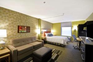 ein Hotelzimmer mit einem Bett und einem Sofa in der Unterkunft Home2 Suites by Hilton Little Rock West in Little Rock