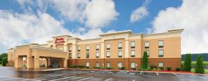 a hotel with a parking lot in front of it at Hampton Inn and Suites of Lamar in Mill Hall