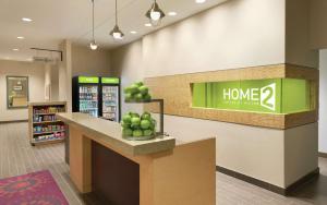 a store lobby with a counter with apples on it at Home2 Suites By Hilton La Crosse in La Crosse