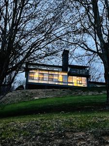 a house on a hill with its lights on at Modern, Sleeps 6, Amazing Views in Maggie Valley