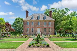 an old brick house with a garden in front of it at Hilton Vacation Club The Historic Powhatan Williamsburg in Williamsburg