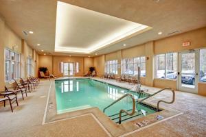 a swimming pool in a hotel room with tables and chairs at Homewood Suites - Doylestown in Warrington