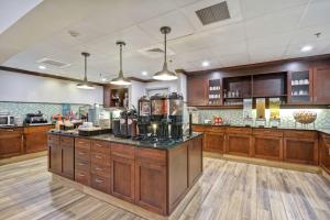 a large kitchen with wooden cabinets and a counter at Homewood Suites by Hilton Palm Desert in Palm Desert