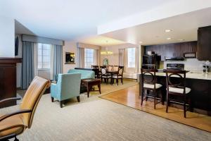 a living room with a kitchen and a dining room at Homewood Suites Port Saint Lucie-Tradition in Port Saint Lucie