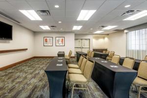 a conference room with tables and chairs and a tv at Homewood Suites Port Saint Lucie-Tradition in Port Saint Lucie +29 photos