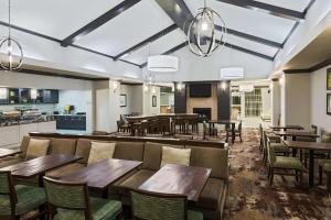 restauracja z drewnianymi stołami i krzesłami oraz kuchnią w obiekcie Homewood Suites by Hilton Princeton w mieście Princeton