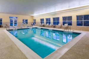 a large swimming pool with blue water in a building at Homewood Suites by Hilton Princeton in Princeton