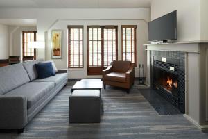 a living room with a couch and a fireplace at Homewood Suites by Hilton Mont-Tremblant Resort in Mont-Tremblant