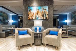 a waiting room with two chairs and a painting on the wall at Hampton Inn Lockport - Buffalo, NY in Lockport