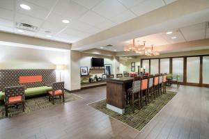 a lobby with a bar and a waiting room at Hampton Inn University Area, Huntington, Wv in Huntington