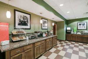 a restaurant with a counter with food on it at Hampton Inn University Area, Huntington, Wv in Huntington