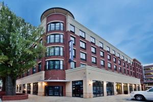 a large red brick building with a clock on it at Hampton Inn & Suites Chapel Hill/Carrboro in Chapel Hill