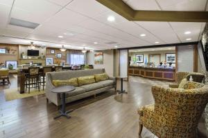 a lobby with a couch and chairs and a bar at Hampton Inn Toledo-South/Maumee in Maumee