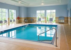 a swimming pool in a hotel room with a pool at Hampton Inn by Hilton Ottawa Airport in Ottawa
