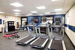 a gym with several treadmills and elliptical machines at Hampton Inn by Hilton Ottawa Airport in Ottawa