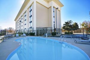 a large swimming pool in front of a building at Hampton Inn Athens in Athens