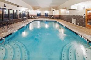 a large swimming pool with blue water in a building at Hampton Inn & Suites Dumas in Dumas