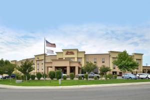 a building with an american flag in front of it at Hampton Inn & Suites Boise-Meridian in Meridian