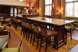 a large bar in a restaurant with chairs and tables at Hampton Inn & Suites Boise-Meridian in Meridian