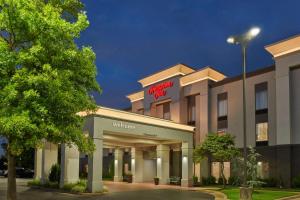 a hotel with a sign on the front of a building at Hampton Inn Bartlesville in Bartlesville