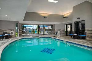 a large swimming pool with blue water in a hotel at Hampton Inn Bartlesville in Bartlesville