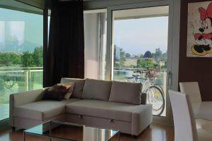 a living room with a couch and a glass table at Suite chocolat in Cuneo