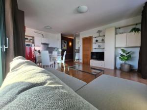 a living room with a couch and a dining room at Suite chocolat in Cuneo