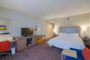 a hotel room with a bed and a flat screen tv at Hampton Inn Crestview South I-10, Fl in Crestview