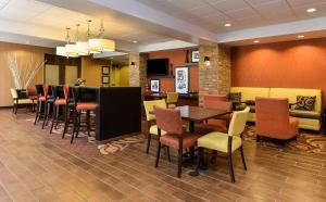 a restaurant with a table and chairs in a room at Hampton Inn Clinton in Clinton
