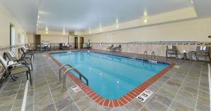 a large pool in a hotel with chairs and tables at Hampton Inn Clinton in Clinton