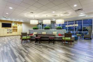 a dining room with a table and chairs in a lobby at Home2 Suites Dover in Dover