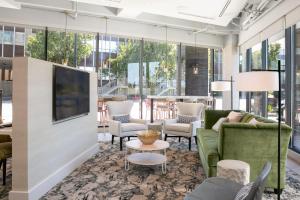 a lobby with couches and chairs and windows at TownePlace Suites Nashville Downtown/Capitol District in Nashville