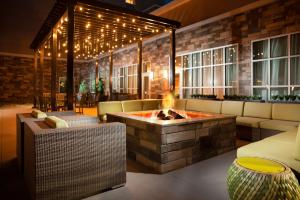 a living room with a fire pit in the middle at Homewood Suites By Hilton Broomfield Boulder in Broomfield