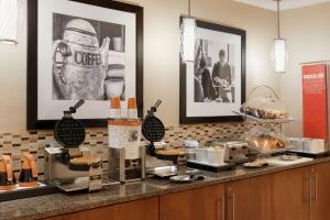 a kitchen with a counter with a coffee station at Hampton Inn West Des Moines Lake Drive in West Des Moines