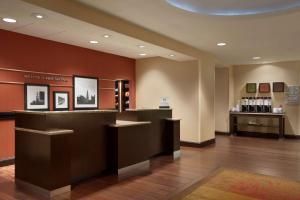 a lobby of a hotel with a counter and a pharmacy at Hampton Inn & Suites East Hartford in East Hartford