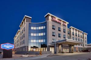 a hotel with a sign on the front of it at Hampton Inn Kearney in Kearney