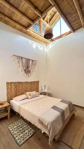 a bedroom with a large bed and a large window at IGUANA HOUSE in Máncora +86 photos