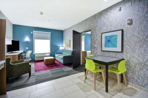 a living room with a table and yellow chairs at Home2 Suites By Hilton Fort Worth Fossil Creek in Fort Worth