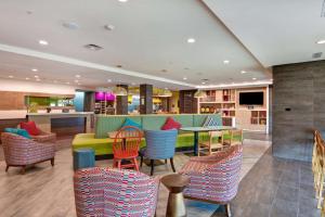 a restaurant with colorful chairs and a table at Home2 Suites By Hilton Hot Springs in Hot Springs