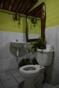 a bathroom with a toilet and a sink at Kawsay- Hospedaje y Alimentacion in Ibarra