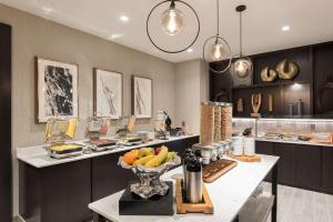 a kitchen with a counter with a bowl of fruit on it at Hilton Garden Inn Hanover Lebanon in Lebanon