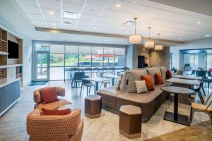 a living room with a couch and chairs and tables at Home2 Suites By Hilton North Little Rock, Ar in North Little Rock