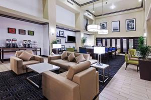 a lobby with couches and tables and a bar at Hampton Inn and Suites Lake Jackson-Clute in Clute
