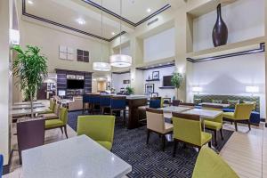 a restaurant with tables and chairs and a cafeteria at Hampton Inn and Suites Lake Jackson-Clute in Clute