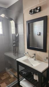 a bathroom with a sink and a mirror at DEPARTAMENTOS CIELO DE CAFAYATE in Cafayate