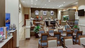 a restaurant with tables and chairs and a bar at Hampton Inn Myrtle Beach Broadway at the Beach in Myrtle Beach