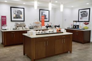 a kitchen with wooden cabinets and a counter top at Hampton Inn & Suites Oklahoma City/Quail Springs in Oklahoma City