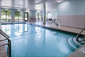 a pool with blue water in a building at Hampton Inn Council Bluffs in Council Bluffs